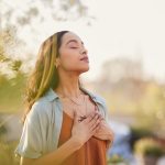 Young,Latin,Woman,With,Hand,On,Chest,Breathing,In,Fresh