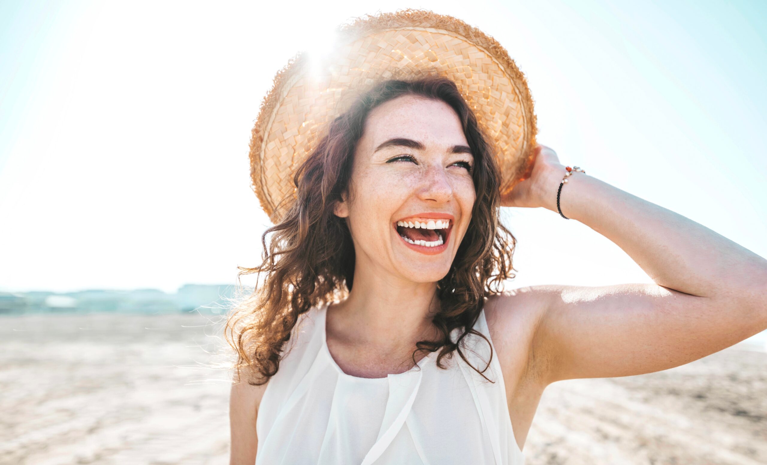 Happy,Beautiful,Young,Woman,Smiling,At,The,Beach,Side,