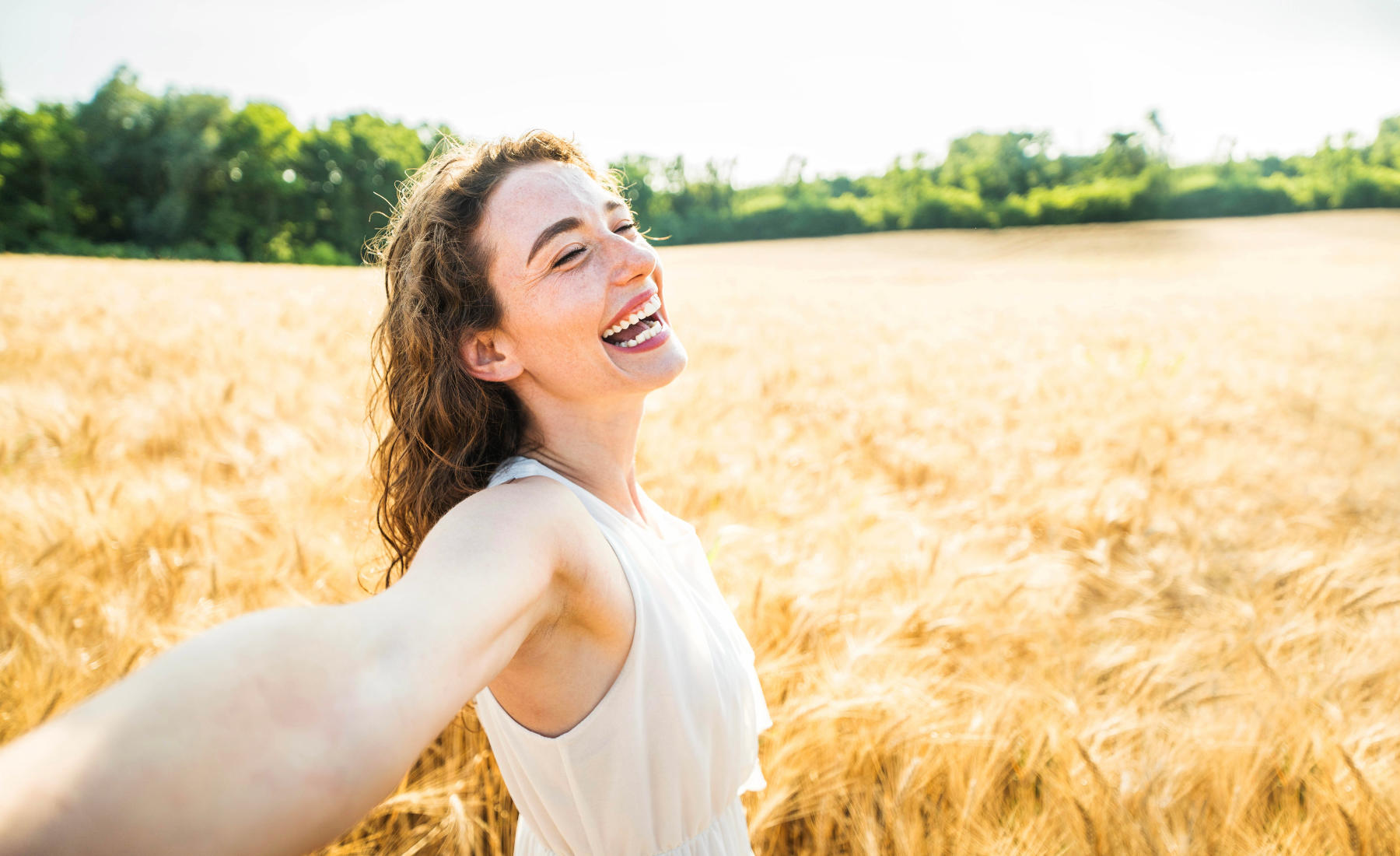 Happy,Woman,With,Arms,Outstretched,Enjoying,Freedom,In,A,Wheat