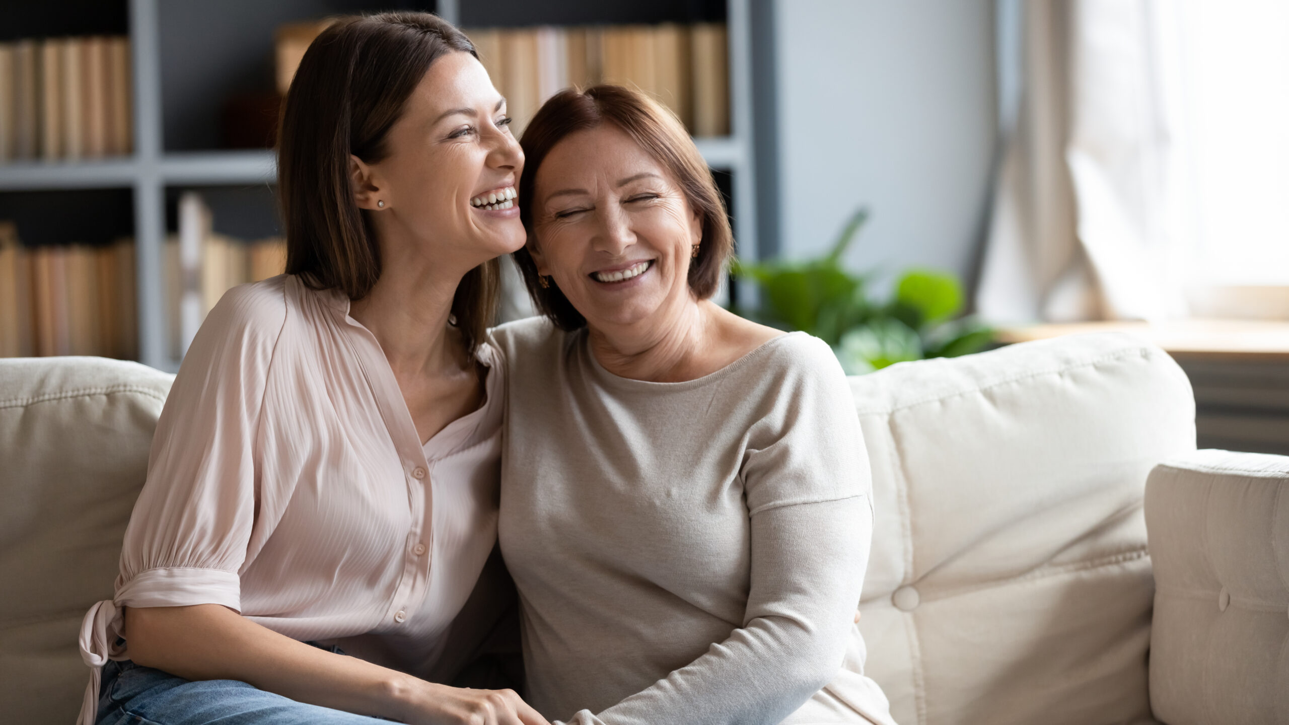 Happy,Senior,Mother,And,Grownup,Daughter,Sit,Relax,On,Couch