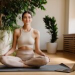 Young,White,Woman,Using,Laptop,During,Yoga,Practice,On,Mat