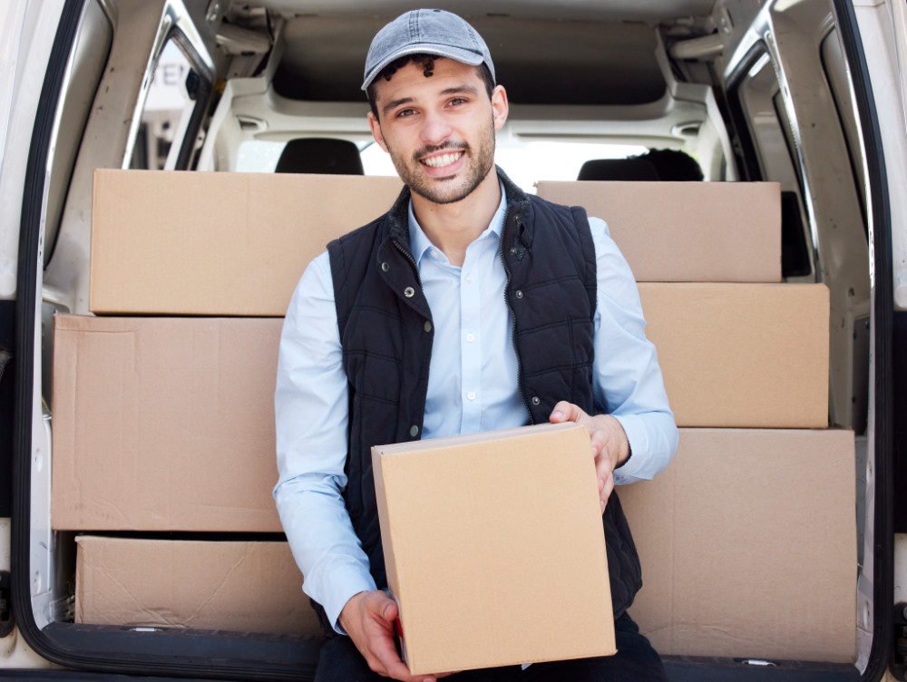 Man holding a package, representing a fast delivery service and logistics support.